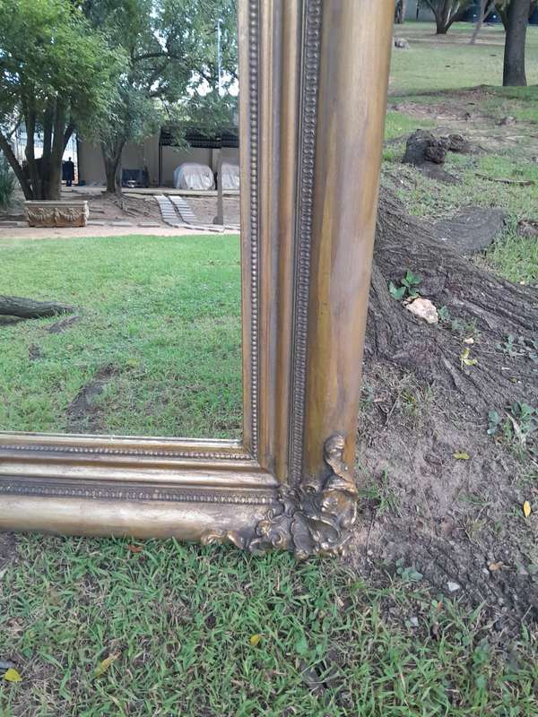 A 20th Century French Style Ornately Carved And Hand Gilded Bevelled Mirror