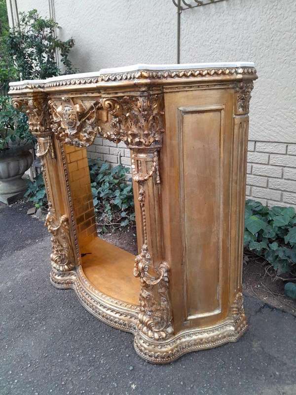 A 20TH Century French Style Ornately Hand Carved and Gilded Fireplace Surround