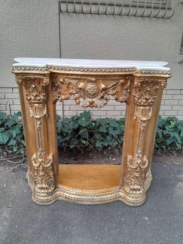 A 20TH Century French Style Ornately Hand Carved and Gilded Fireplace Surround