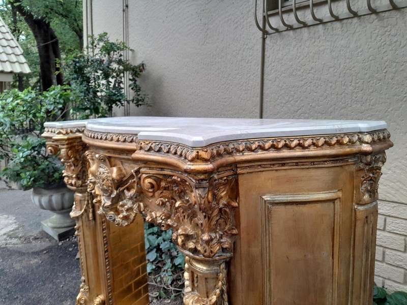 A 20TH Century French Style Ornately Hand Carved and Gilded Fireplace Surround