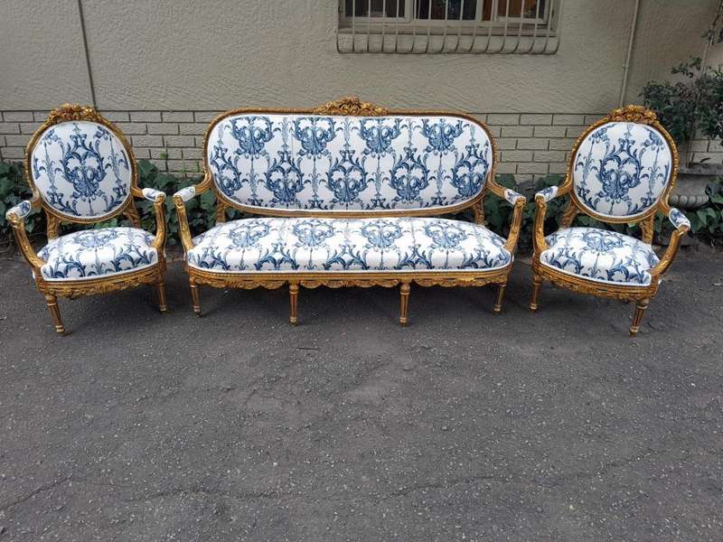 A 20TH Century French Louis XVI Style Set Of A Carved And Gilded Settee And Pair Of Armchairs