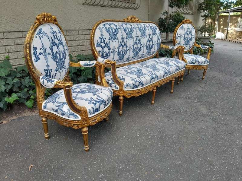 A 20TH Century French Louis XVI Style Set Of A Carved And Gilded Settee And Pair Of Armchairs