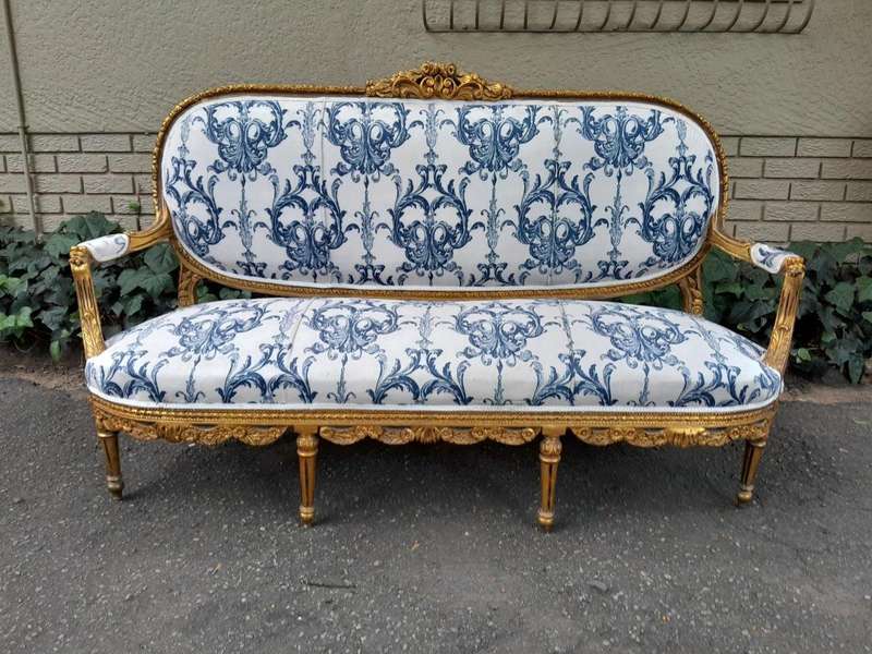 A 20TH Century French Louis XVI Style Set Of A Carved And Gilded Settee And Pair Of Armchairs