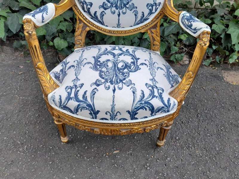 A 20TH Century French Louis XVI Style Set Of A Carved And Gilded Settee And Pair Of Armchairs