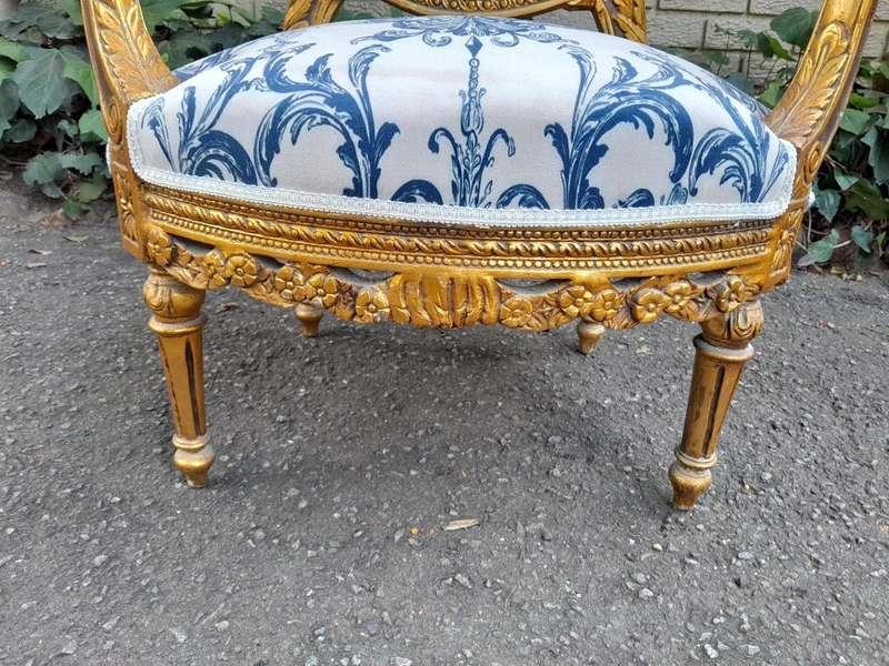 A 20TH Century French Louis XVI Style Set Of A Carved And Gilded Settee And Pair Of Armchairs
