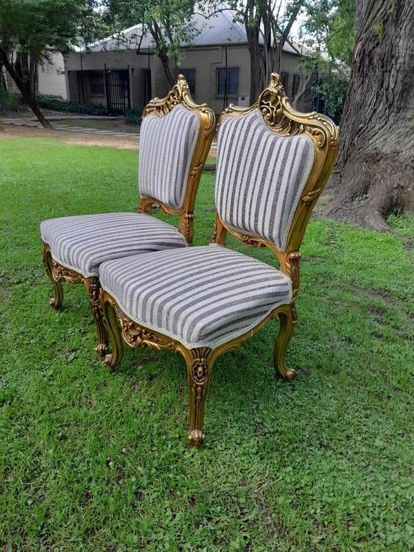 A Pair of French Rococo Style Carved Wooden Gilded Armchairs