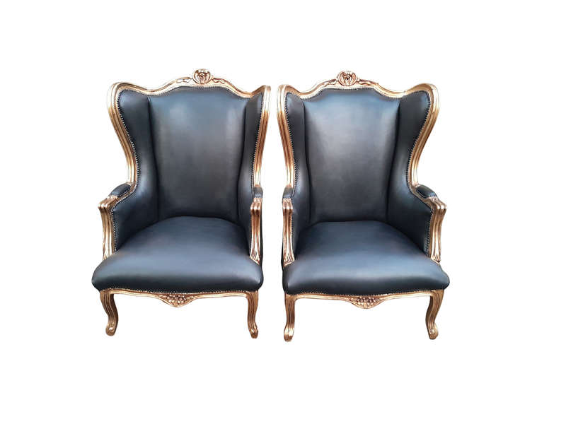 A Pair Of French Style Louis XVI Style Carved And Hand Gilded Wingback Chairs Upholstered In Leather