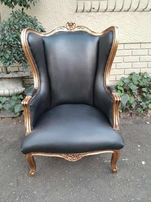 A Pair Of French Style Louis XVI Style Carved And Hand Gilded Wingback Chairs Upholstered In Leather