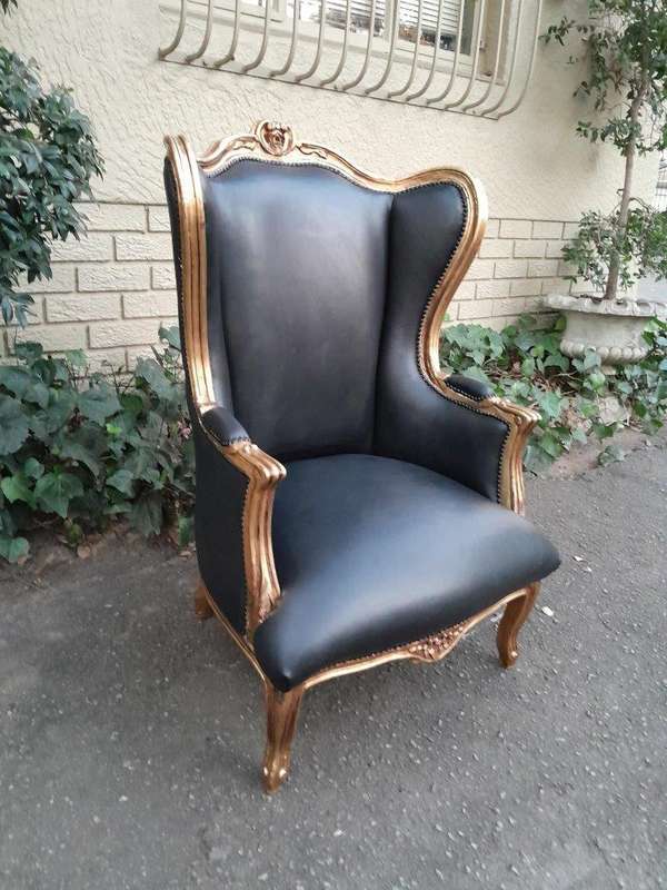 A Pair Of French Style Louis XVI Style Carved And Hand Gilded Wingback Chairs Upholstered In Leather