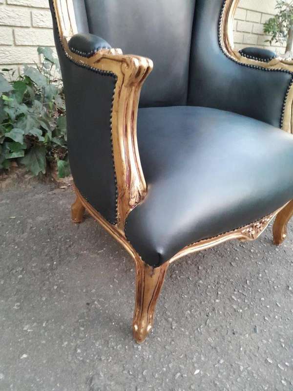 A Pair Of French Style Louis XVI Style Carved And Hand Gilded Wingback Chairs Upholstered In Leather