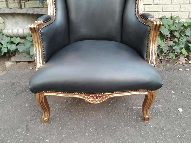 A Pair Of French Style Louis XVI Style Carved And Hand Gilded Wingback Chairs Upholstered In Leather
