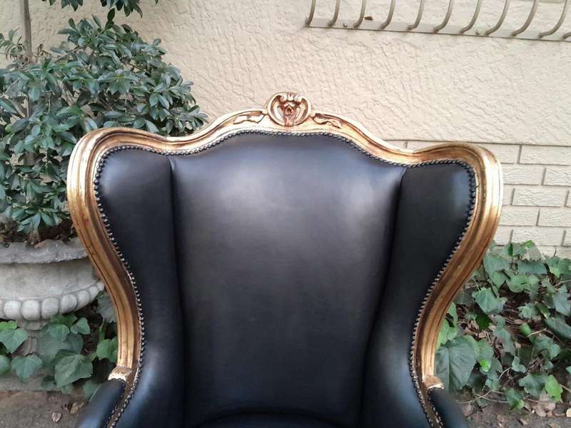 A Pair Of French Style Louis XVI Style Carved And Hand Gilded Wingback Chairs Upholstered In Leather