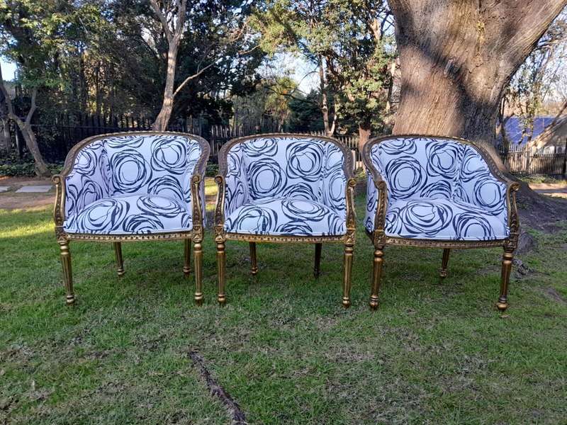 A 20th Century French Louis Bergere Style Set Of Three Carved and Gilded Chairs in a Custom Made ...
