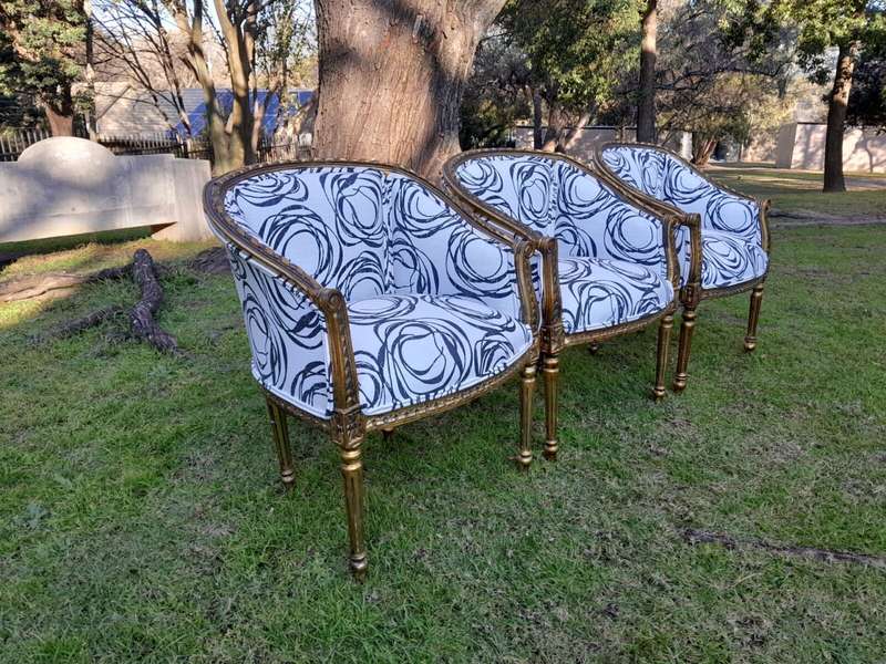 A 20th Century French Louis Bergere Style Set Of Three Carved and Gilded Chairs in a Custom Made ...