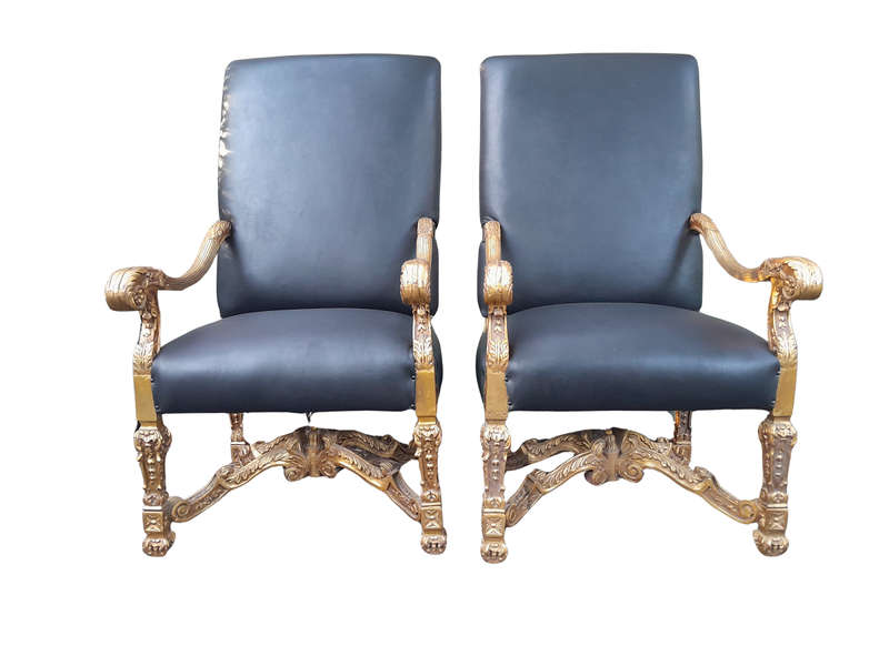 A 20th Century French Style Carved and Giltwood Arm Chairs Upholstered in Leather)