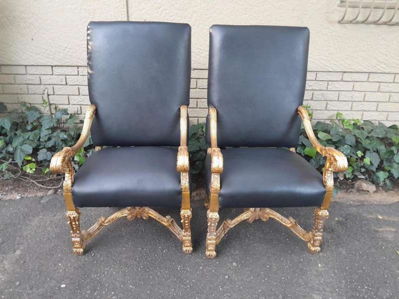 A 20th Century French Style Carved and Giltwood Arm Chairs Upholstered in Leather)