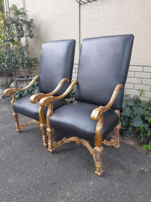 A 20th Century French Style Carved and Giltwood Arm Chairs Upholstered in Leather)