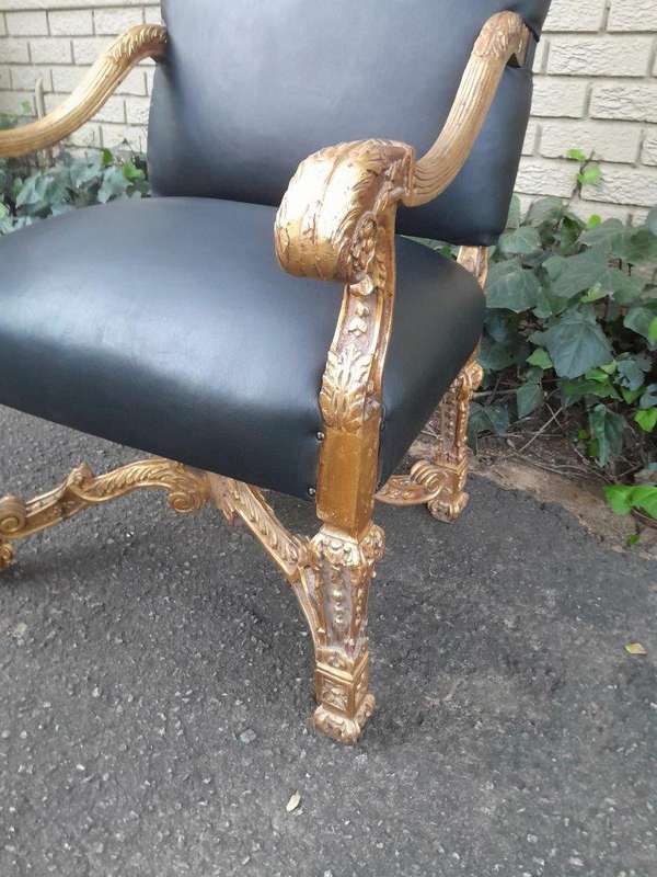 A 20th Century French Style Carved and Giltwood Arm Chairs Upholstered in Leather)