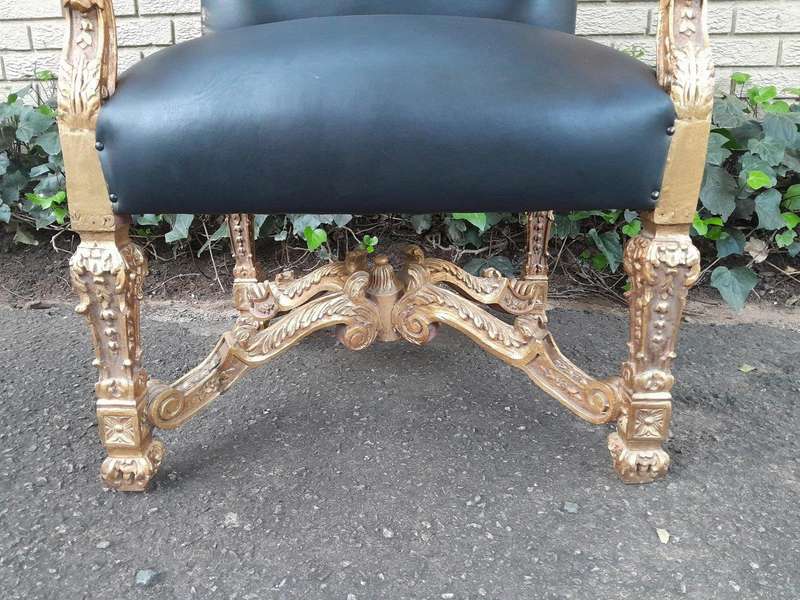 A 20th Century French Style Carved and Giltwood Arm Chairs Upholstered in Leather)