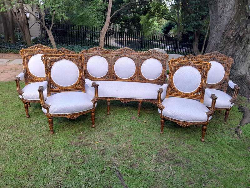 A 20th Century French Louis XVI Style Five Piece Set of Giltwood Settee and Four Armchairs