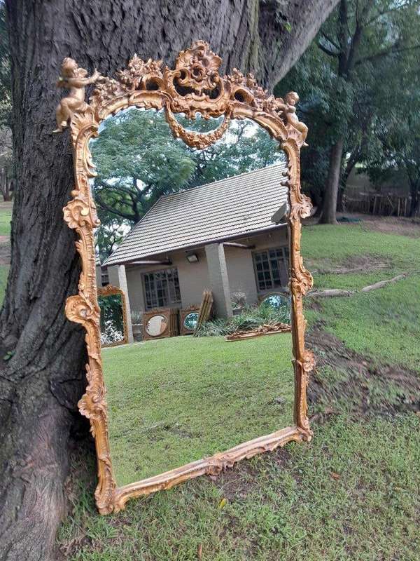 A French Rococo Style Ornately Carved and Gilded Bevelled Mirror 1