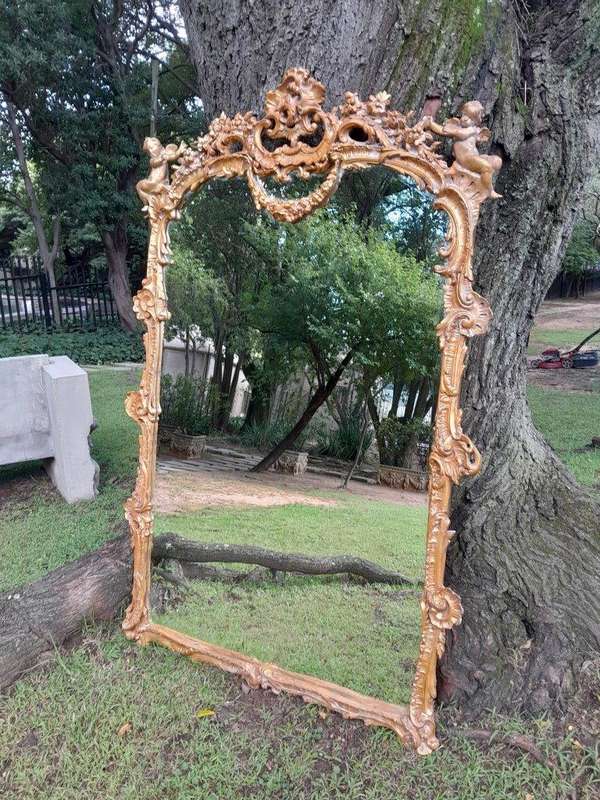 A French Rococo Style Ornately Carved and Gilded Bevelled Mirror 1