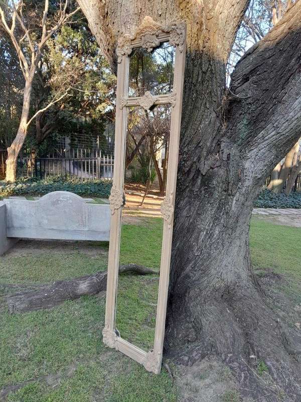 A French Style Ornately Carved And Bevelled Mirror In A Natural  /  Bleached Finish