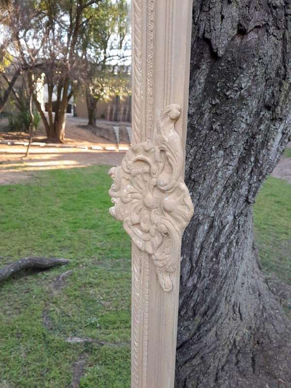 A French Style Ornately Carved And Bevelled Mirror In A Natural  /  Bleached Finish