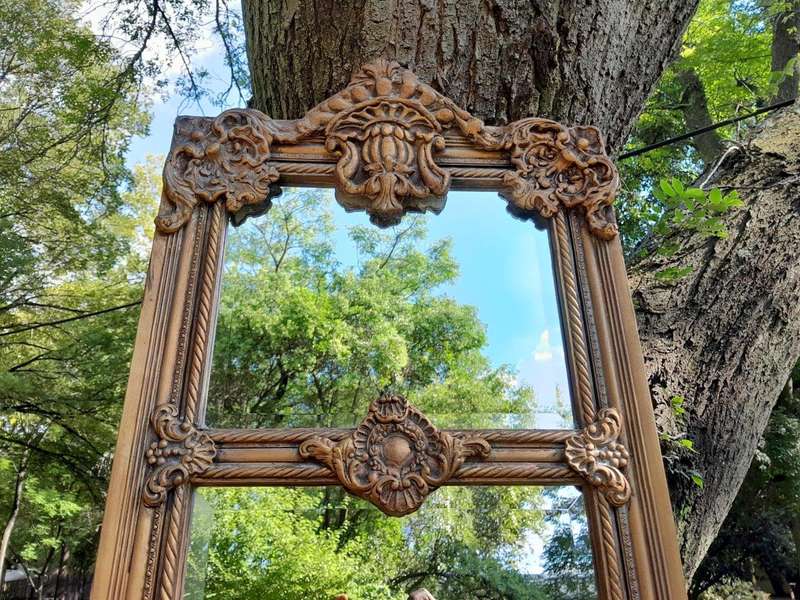 A French Style Ornately Carved and Gilded Bevelled Mirror
