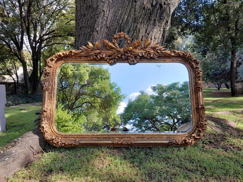 A French Style Ornately Carved and Gilded Bevelled Mirror