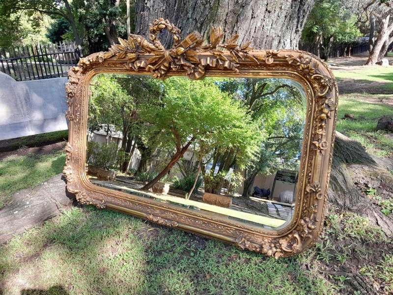 A French Style Ornately Carved and Gilded Bevelled Mirror