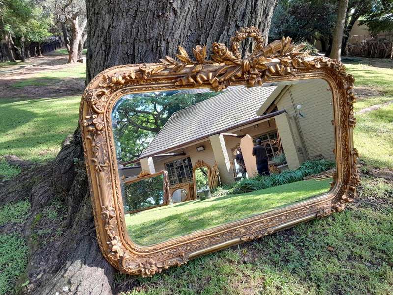 A French Style Ornately Carved and Gilded Bevelled Mirror