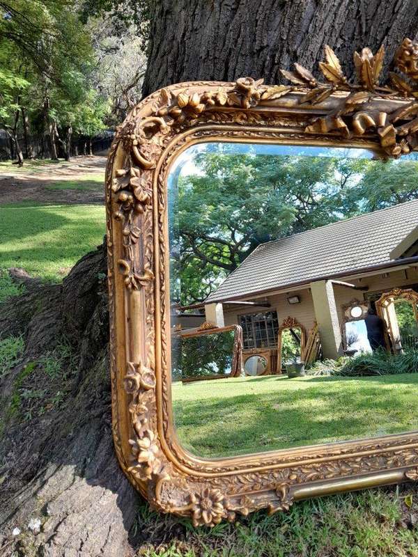 A French Style Ornately Carved and Gilded Bevelled Mirror