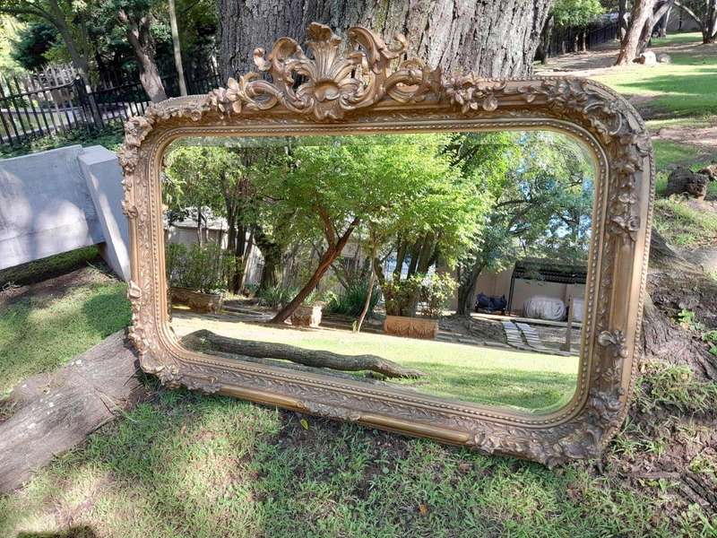 A French Style Ornately Carved and Gilded Bevelled Mirror
