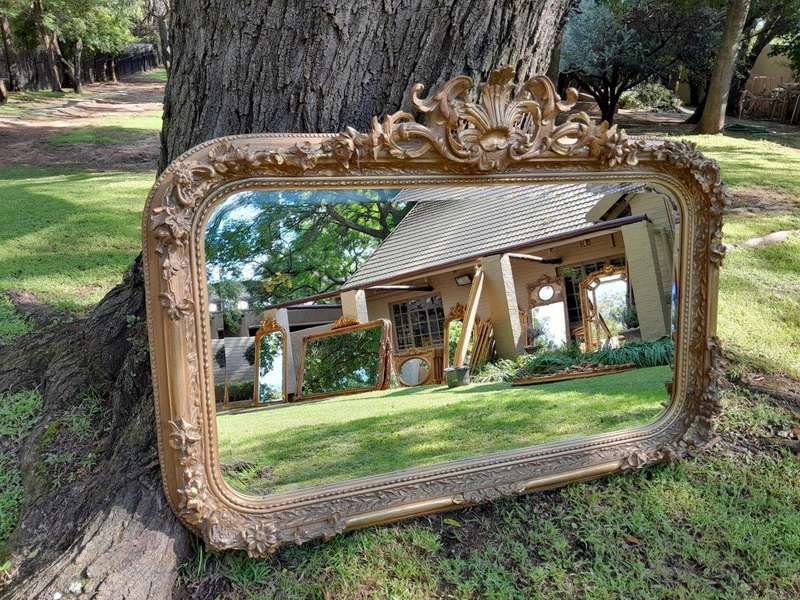 A French Style Ornately Carved and Gilded Bevelled Mirror