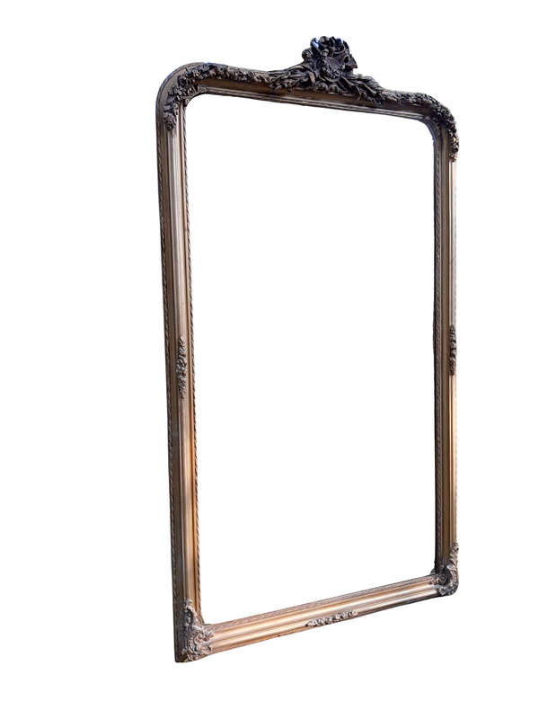 A Large French Style Ornately Carved and Gilded Bevelled Mirror