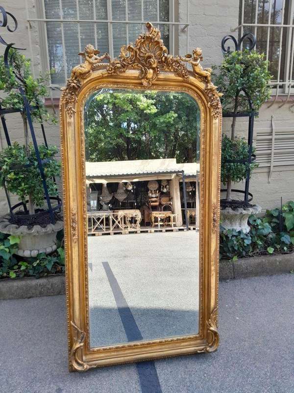 A French Style Ornately Carved And Gilded Bevelled Mirror