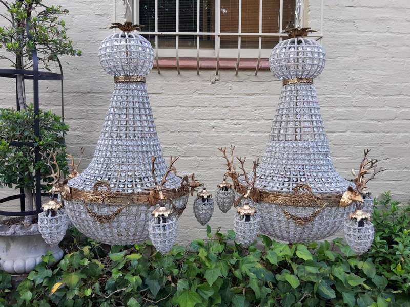 A French Style Pair of Aged Brass Pair of Monumental Empire Style Chandeliers with Deer Head Figures