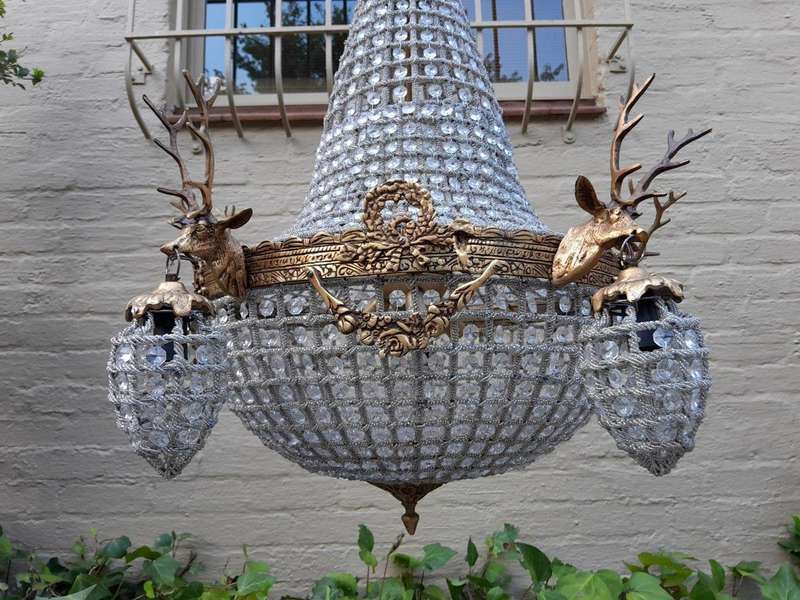 A French Style Pair of Aged Brass Pair of Monumental Empire Style Chandeliers with Deer Head Figures