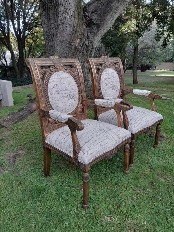 A 20TH Century French Style Pair of Ornately Carved and Gilded Armchairs Upholstered in a Custom-...