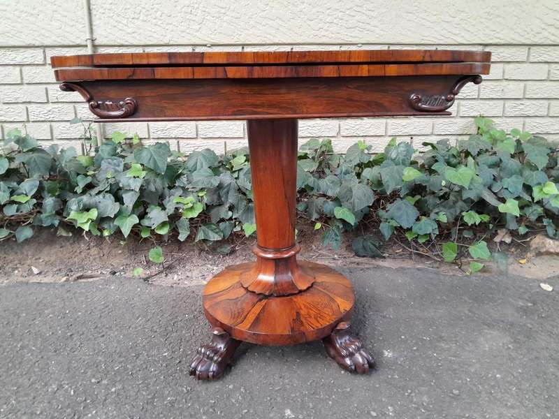 A 19TH Century William IV Rosewood Fold-over Card Table With Paw Feet