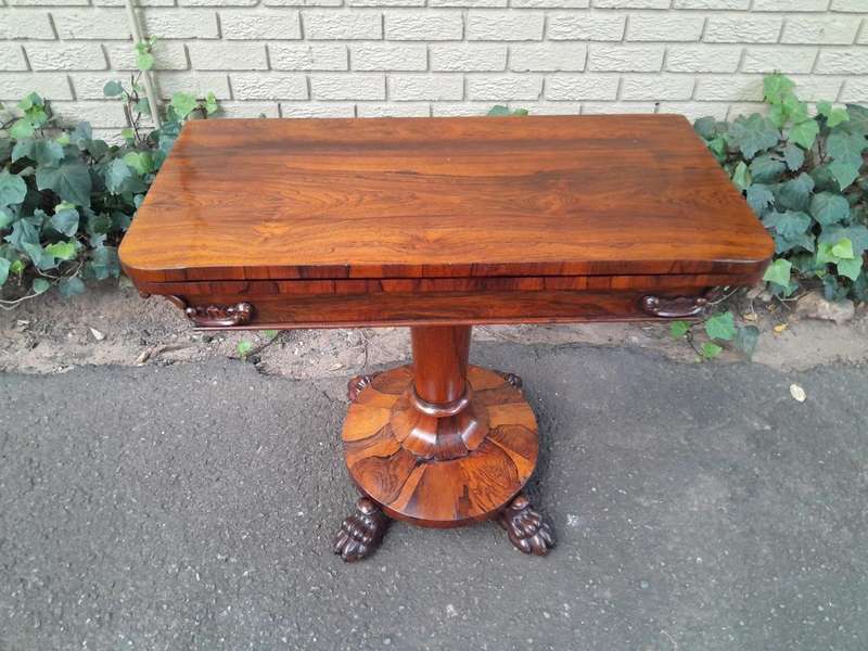 A 19TH Century William IV Rosewood Fold-over Card Table With Paw Feet