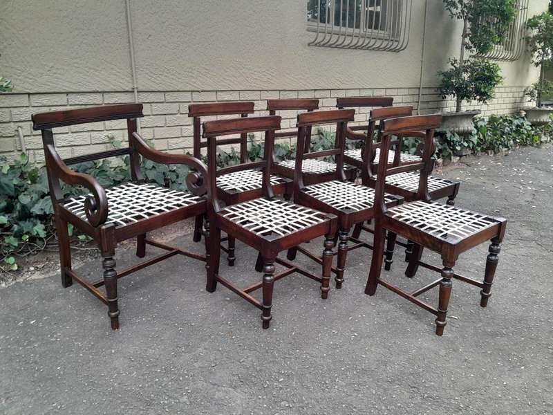 A 19th Century Set of Eight Cape Stinkwood Dining Charis with Riempie Seat Comprising Two Carvers...