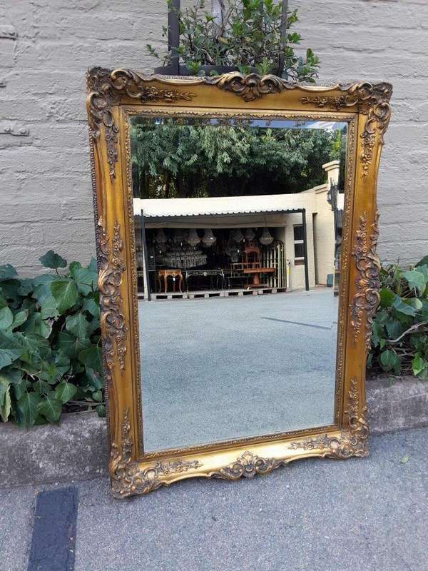 A 20th Century Heavily Carved, Gilded and Bevelled Mirror