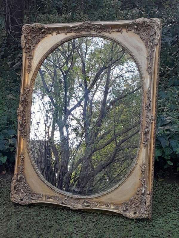 A 20TH Century Ornately Carved Gilt Wood Mirror