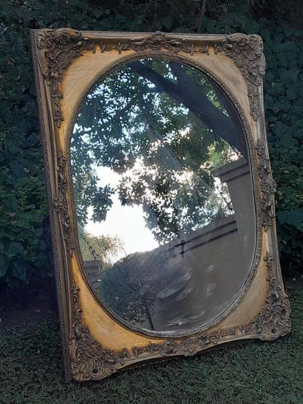 A 20TH Century Ornately Carved Gilt Wood Mirror