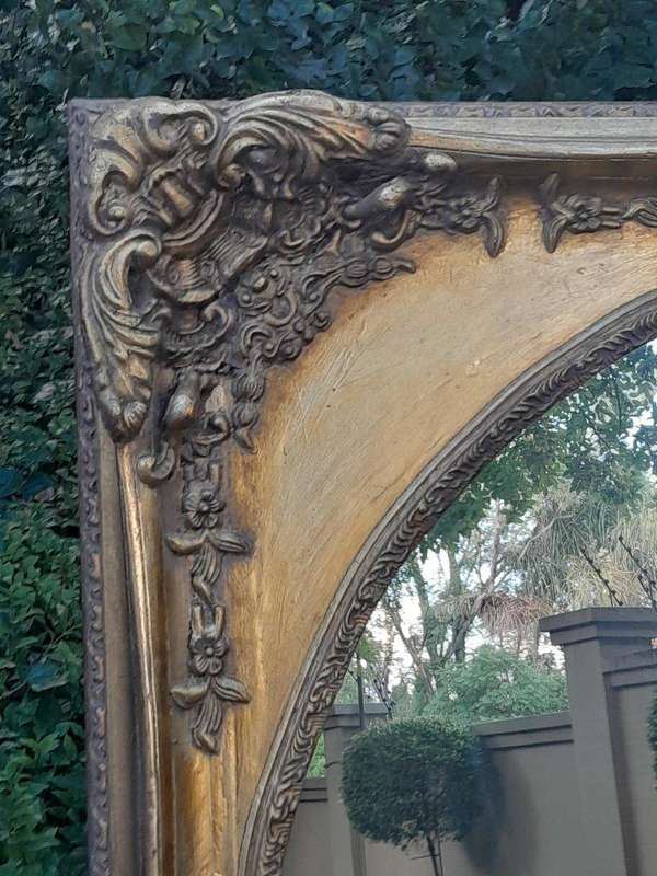 A 20TH Century Ornately Carved Gilt Wood Mirror