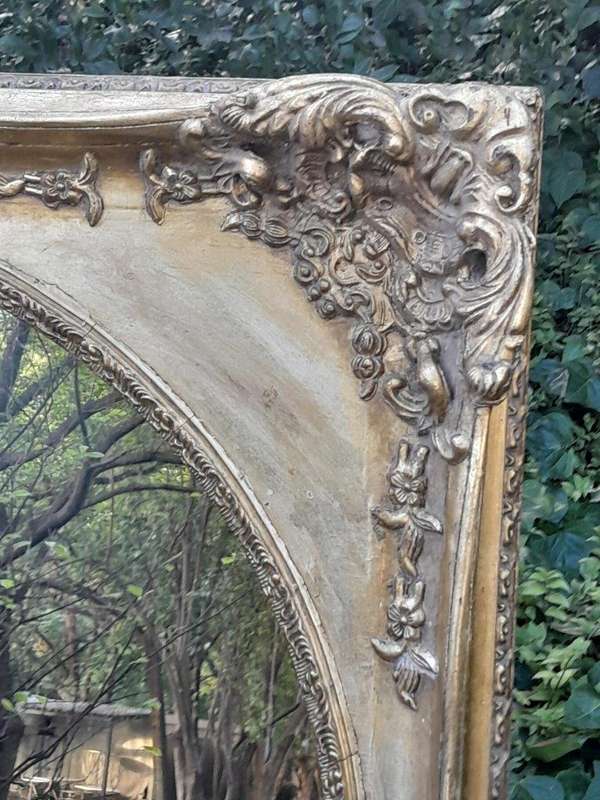 A 20TH Century Ornately Carved Gilt Wood Mirror