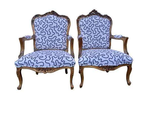 A 20th Century French Style Ornately Carved And Gilded Wooden Armchairs