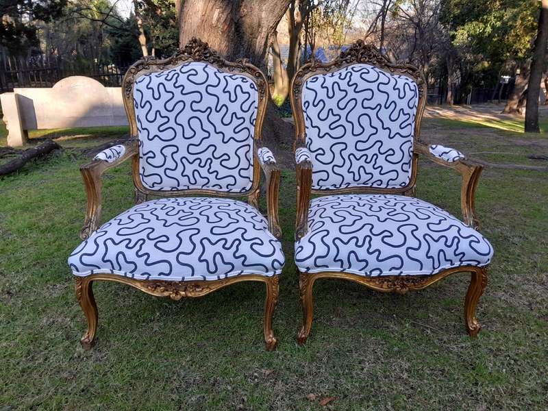 A 20th Century French Style Ornately Carved And Gilded Wooden Armchairs